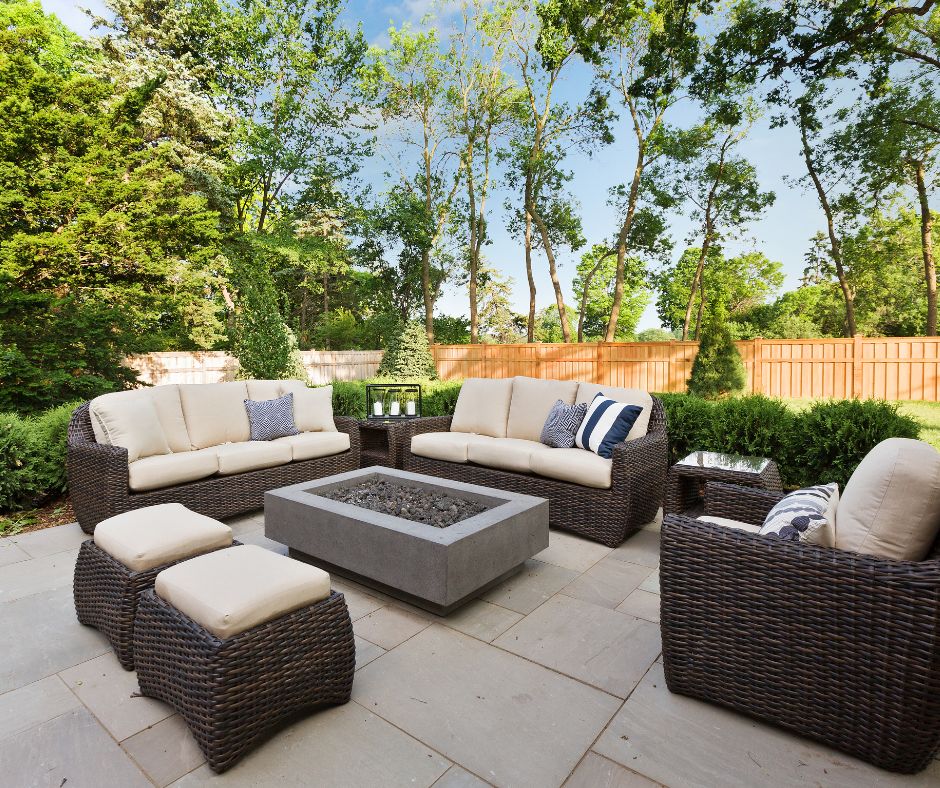 Outdoor patio area with comfortable seating around a gas firepit