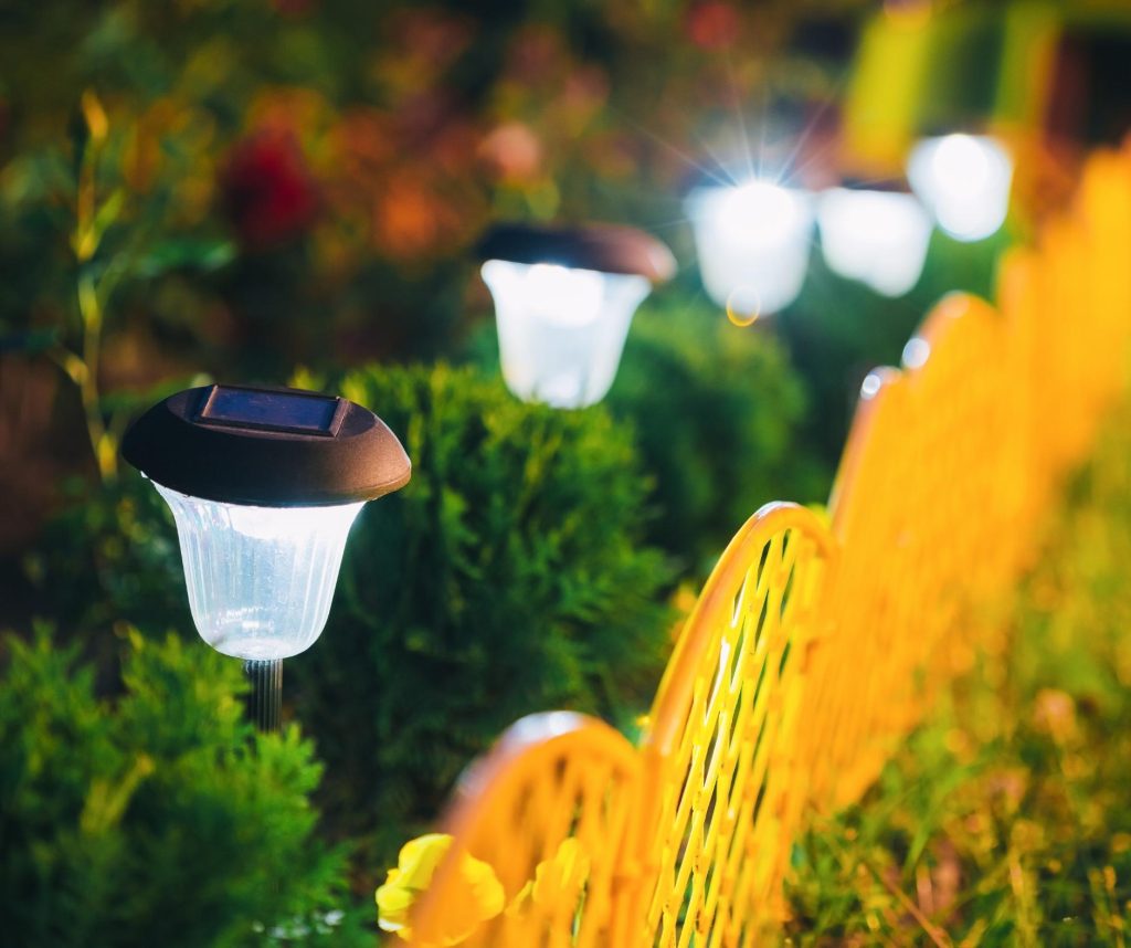 Small Solar Garden Light, Lantern In Flower Bed. Garden Design. Solar Powered Lamp